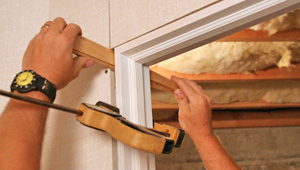 Installing trim and finishing touches to a remodeled basement in Millville, NJ