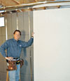 Installing wall panels on top of our basement wall insulation in Absecon