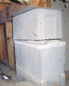 Concrete crawl space support posts in Pleasantville that are showing signs of failure as they sink into the earth.