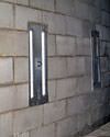 an inside view of foundation wall anchors installed along a basement wall to brace and repair the structure in Mannahawkin
