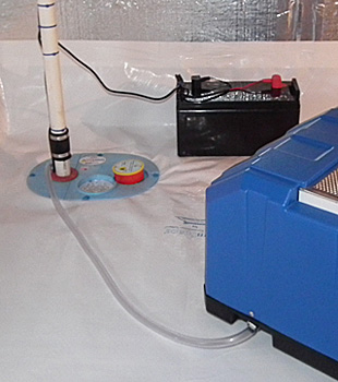 Closeup of a crawl space sump pump installed in Millville