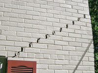 Stair-step cracks showing in a home foundation in Pleasantville