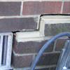 A closeup of a failed tuckpointing job where the brick cracked on a Margate City home.