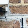 Failed crack repair showing old tuckpointing that cracked on a Clementon home.