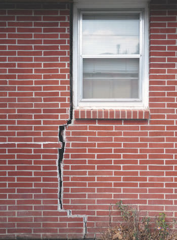 severe foundation wall cracks along a window in Manchester Township