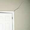 A long drywall crack beginning at the corner of a doorway in a Winslow home.
