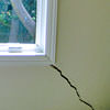 A long, diagonal crack that begins at a window corner of a Glassboro home