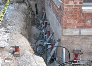 Foundation push piers installed around a house with a foundation settlement issues in Egg Harbor City
