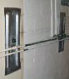 Foundation wall anchor plates installed in a basement in Clementon
