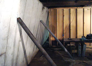 A severely tilting foundation wall propped up by steel beams in Margate City.