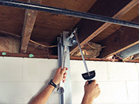 Straightening a foundation wall with the PowerBrace™ i-beam system in a Marlton home.