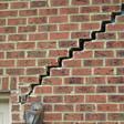 stair step cracking reaching from a window along the foundation wall in Clementon