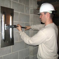 installing a wall anchor to repair an bowing foundation wall in Marlton