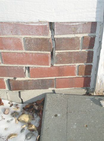 Severe street creep damage to a garage wall outside a Somers Point home