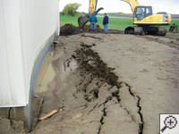 A foundation wall showing severe damage from bowing and buckling in Hammonton