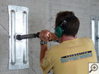 Mounting the steel wall plate for foundation wall repair and straightening in Havertown.