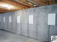 Wall anchor covers installed along a foundation wall that has been straightened in Margate City.