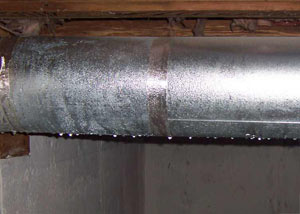 condensation collecting on an HVAC vent in a humid Williamstown basement