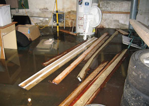 A severely flooding basement in Absecon, with lumber and personal items floating in a foot of water