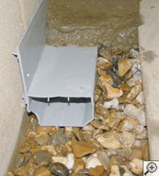 A no-clog basement french drain system installed in Sewell