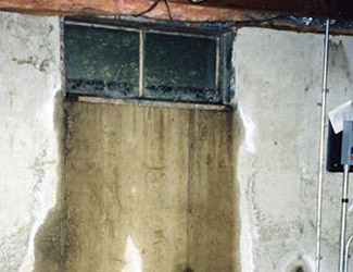 Water pouring out from a basement window in Philadelphia